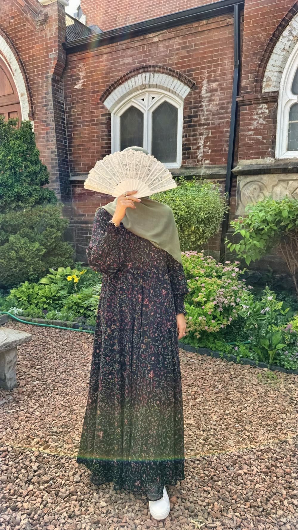 A black floral dress with a lace fan